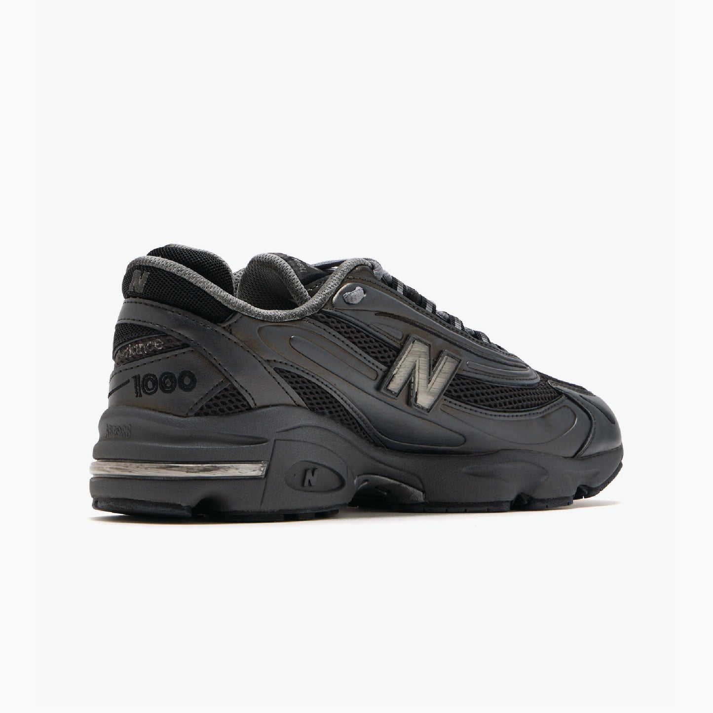 New Balance 1000 sneaker in a black colorway with metallic silver accents.